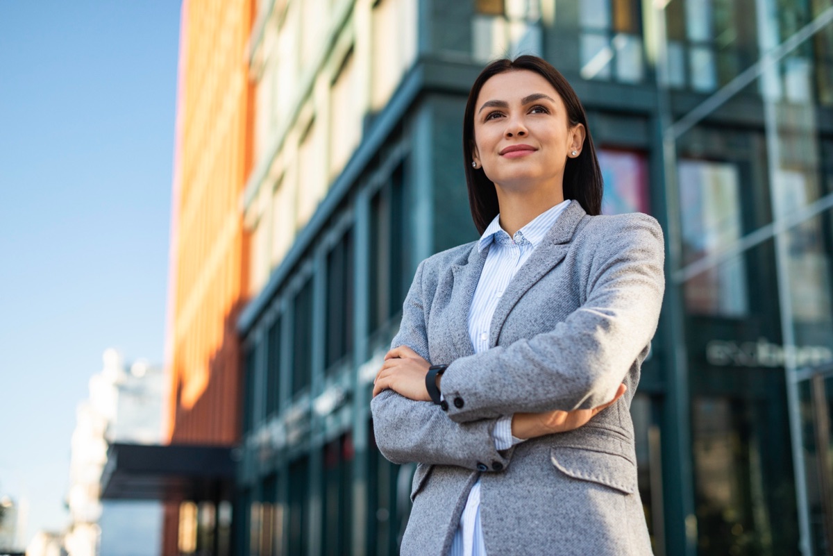 Confident young entrepreneur in front of city buildings